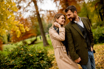 Young couple walking in the autumn park