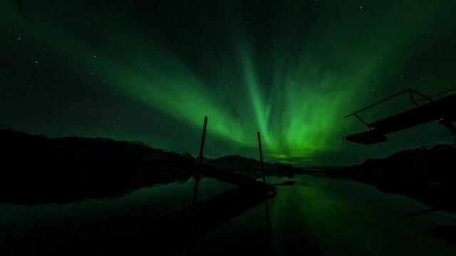 Aurora over broken dock in Knik River, Alaska.