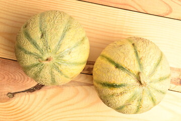fragrant organic melons, close-up, on a white wooden table.