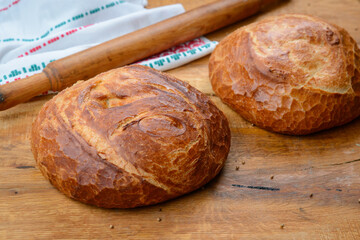 Loaf of bread on wooden table crunchy baked