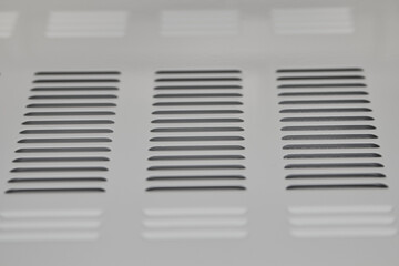 ventilation grille,white ventilation grille on the wall close up at an angle mounted