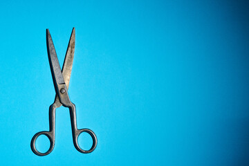 old scissors on a blue background