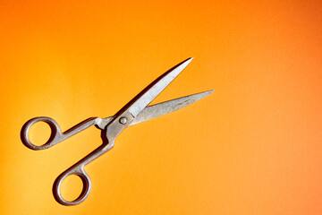 old scissors on a orange background