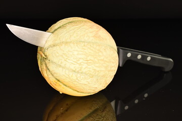  fragrant organic melons, close-up, on a black background.