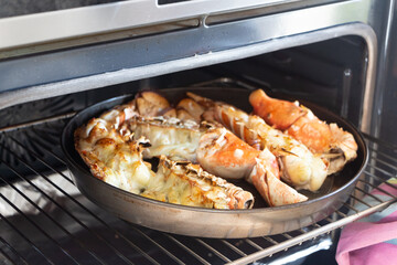 To remove the grilled lobster from the oven