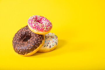 Colorful delicious three donuts with sugar glaze on top