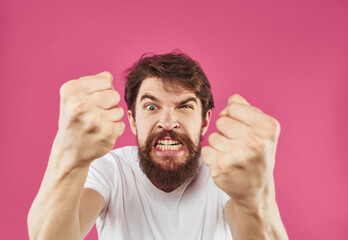 Man on a pink background surprise irritability emotions and stress
