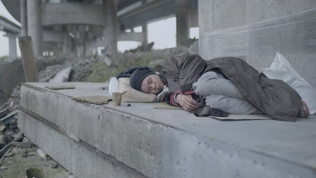 Woman in need sleeping on the cartoon, homeless migrant under the bridge, crisis