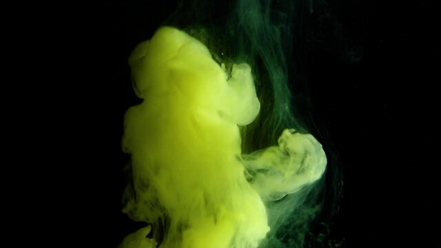 Smoke on a black background. Yellow smoke is slowly rising up