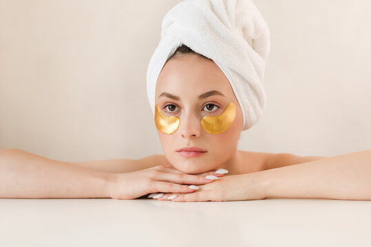 Beauty face woman natural healthy cosmetic skin pure suresh beautiful female happy smile portrait manicure hand. Beauty portrait of an attractive girl with a gold patch under the eyes.