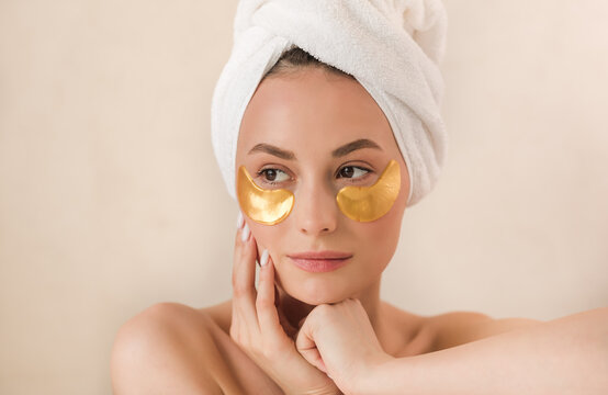 Beauty face woman natural healthy cosmetic skin pure suresh beautiful female happy smile portrait manicure hand. Beauty portrait of an attractive girl with a gold patch under the eyes.