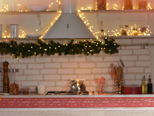 Happy New Year and Merry Christmas! Christmas kitchen. Wooden table with gingerbread, honey, shiksha. Beautiful bokeh in the background.Copy space for text