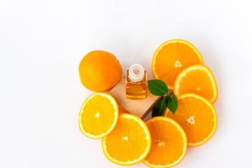 Orange oil for the body. Sliced orange on a white background. Organic SPA cosmetics with herbal ingredients.