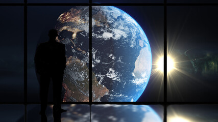 Man looking at planet earth through a window