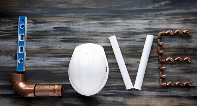 The inscription LOVE  made up with construction tools.
valentines composition with plumbing tools ,copy space. 