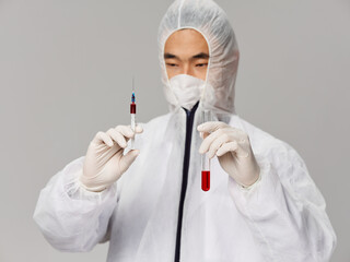 A man holds a syringe vaccine laboratory in his hands Science medicine