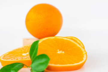 Cut orange on a white background. Natural orange fruit with cut slices. Vitamin C.