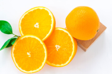 Cut orange on a white background. Natural orange fruit with cut slices. Vitamin C.