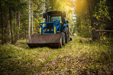 Fototapeta na wymiar Lonely blue tractor in the autumn forest.