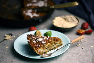 Fragrant delicious piece of oat cake on a plate. Oatmeal cake with seeds and fruits.