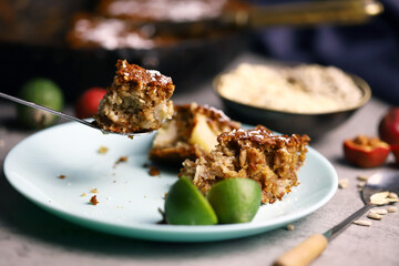Fragrant delicious piece of oat cake on a plate. Oatmeal cake with seeds and fruits.