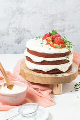 Red velvet cake on wood board. Strawbwrry cake. Devils cake. Wedding dessert. Birthday party. Delicious dessert. Traditional american dessert.