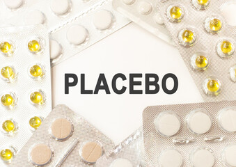 Text placebo on white background. There are various pills and vitamins around. Medical concept
