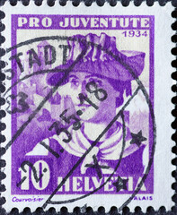 Switzerland - Circa 1934 : a postage stamp printed in the swiss showing the portrait of a Valais woman in historical costume in the background Valere Castle
