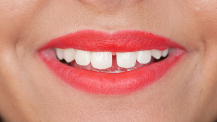 Fototapeta premium Woman with tooth gap and red lips smiles