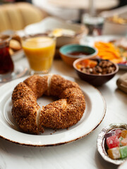 bagel with sesame seeds on a white plate on the background of breakfast