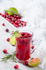 Christmas cranberry drink with berries, lime, and rosemary.