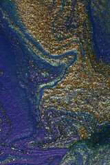 Blue and gold abstract makeup background.Shimmer backdrop.Beautiful stains of liquid nail laquers.Fluid art,pour painting technique.Vertical banner,border for chat.