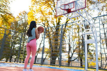 Female basketball player getting ready to make a ball throw to the basket