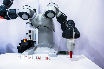 The robot adds cubes with letters