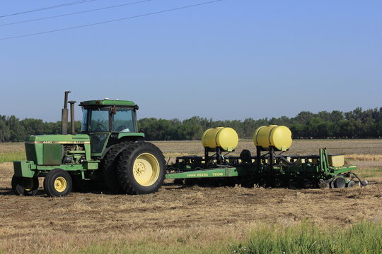 John Deere Tractor In A Farm Field With Blue Sky And Grass By Marion Kansas Out In The Country.