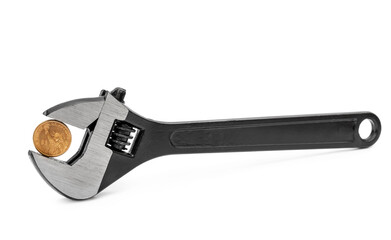 Coin of one dollar in adjustable wrench on white.