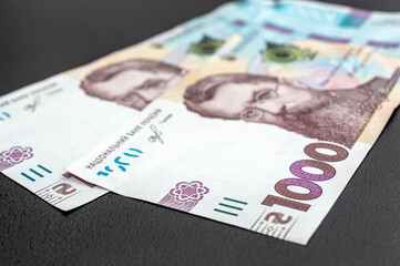 New ukrainian one thousand hryvnia banknotes on black background.