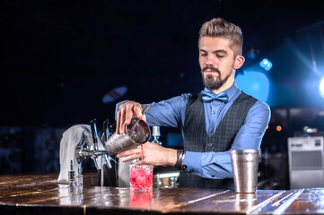 Barman formulates a cocktail on the alehouse