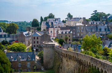 Fototapeta na wymiar Dinan, France - August 26, 2019: View of the historic town and medieval ramparts which still surround the Old Town of Dinan in French Brittany