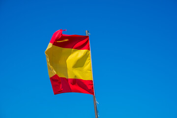 Spanish national flag with blue sky the background