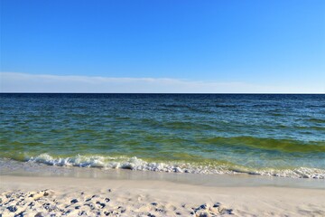 Fototapeta na wymiar Sand, ocean, sky, tranquility and relaxation, photo taken on the beach of Santa Rose Island, Gulf of Mexico