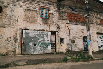 Exterior of an old building with graffitis and worn walls