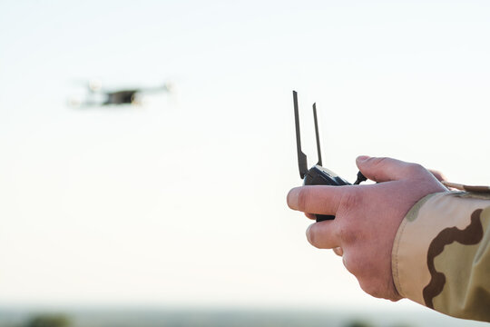 Person controlling drone from the distance, selective focus