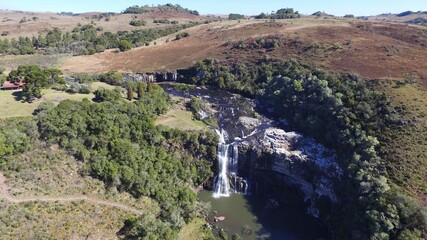 Fototapeta na wymiar Princesa dos Campos Waterfall - Jaquirana - Rio Grande do Sul. Aerial view of a beautiful waterfall among natural fields