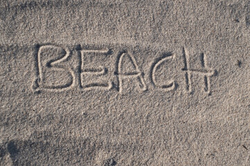 "Beach" written on sand with empty copy space. Writing on sand beach.