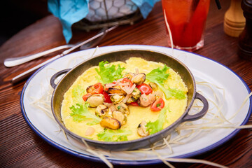 omelet with seafood in a pan