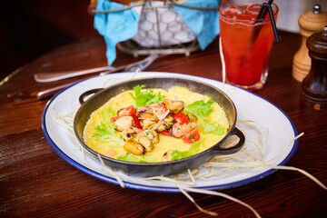 omelet with seafood in a pan