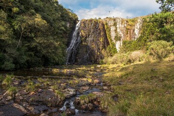 Juvenal Waterfall in São José dos Ausentes - RS. Beautiful waterfall between fields and a pine valley in Rio Grande do Sul