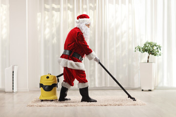 Santa claus using a vacuum cleaner