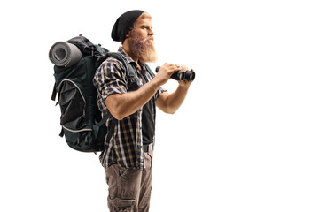 Young bearded man hiker holding binoculars